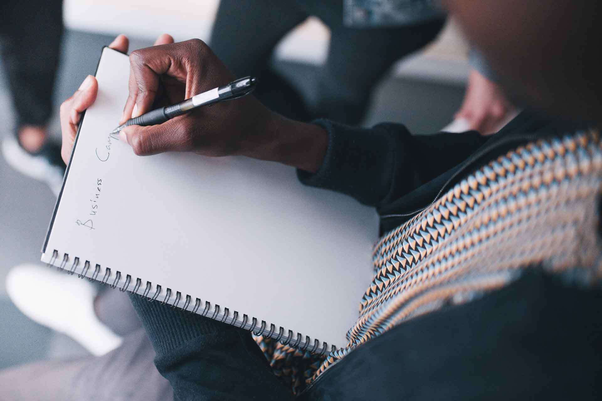 Person writing in book